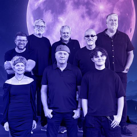 Bandmitglieder in dunkler Kleidung stehen vor einem animierten Vollmond, der blau-violettes Licht ausstrahlt